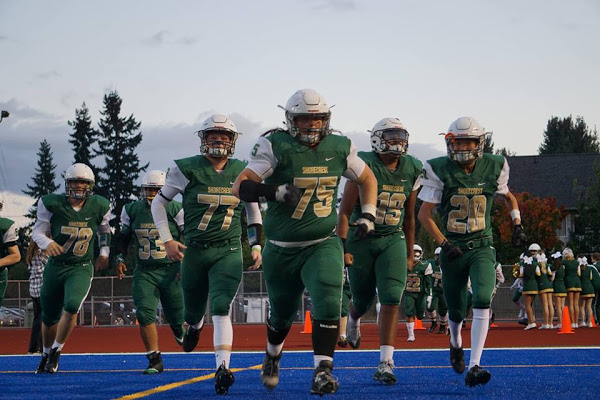 The Scots charge onto the football field before their victory against Shorewood.