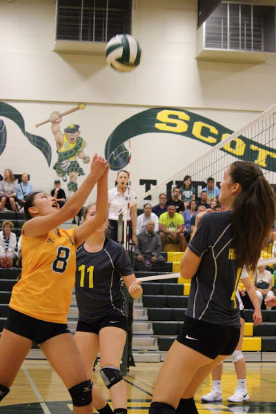 Sophomore Emily Pan bumps the volleyball with the support of her teammates.