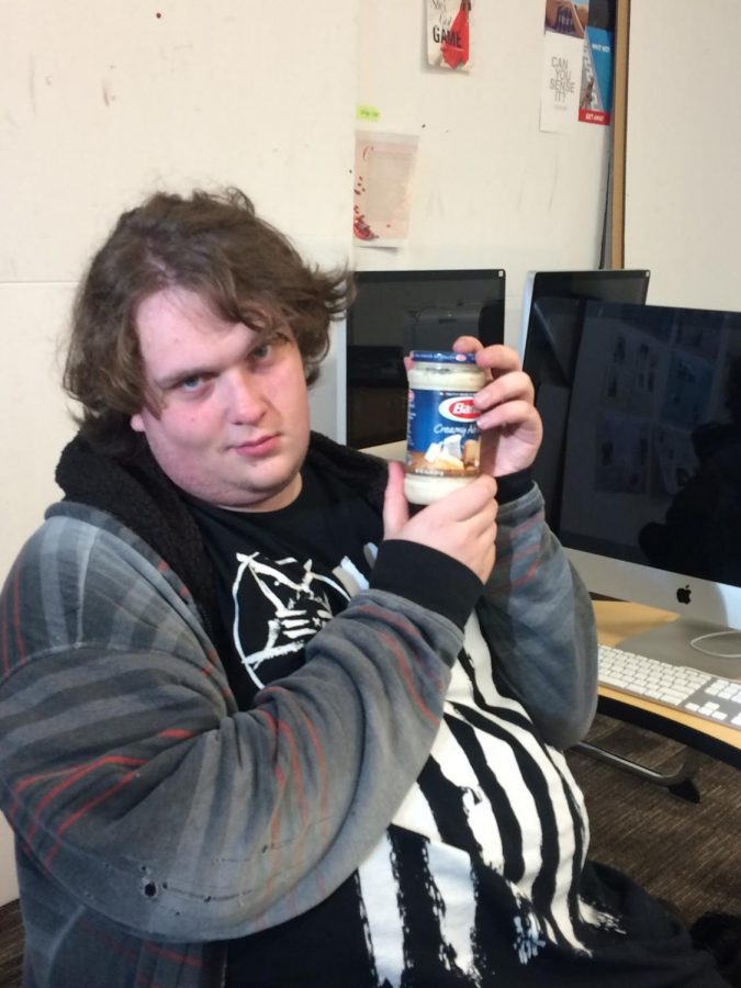 Shorecrest senior Zack Zaike poses with a jar of canned goods.